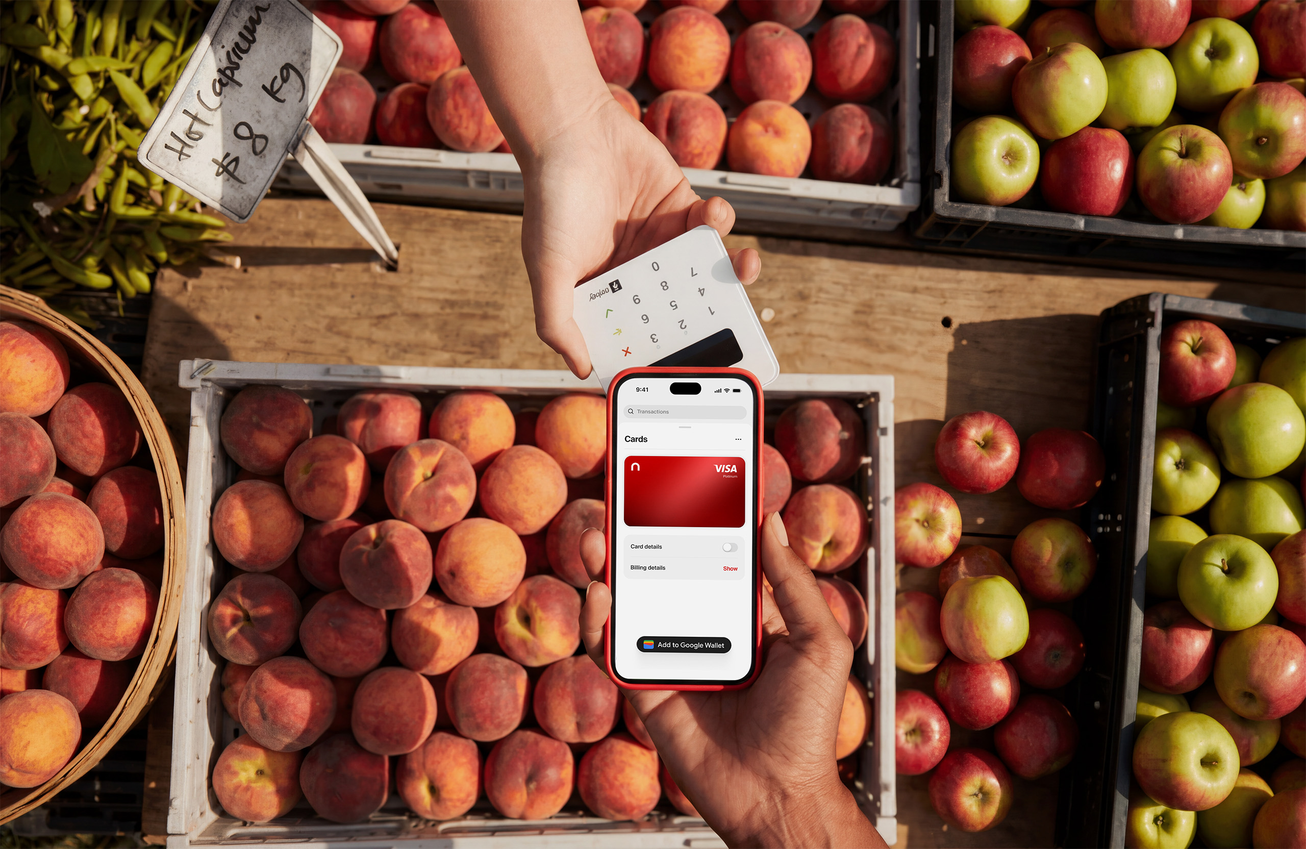 Tapping a phone with the nsave card to a contactless reader at a fruit market stall