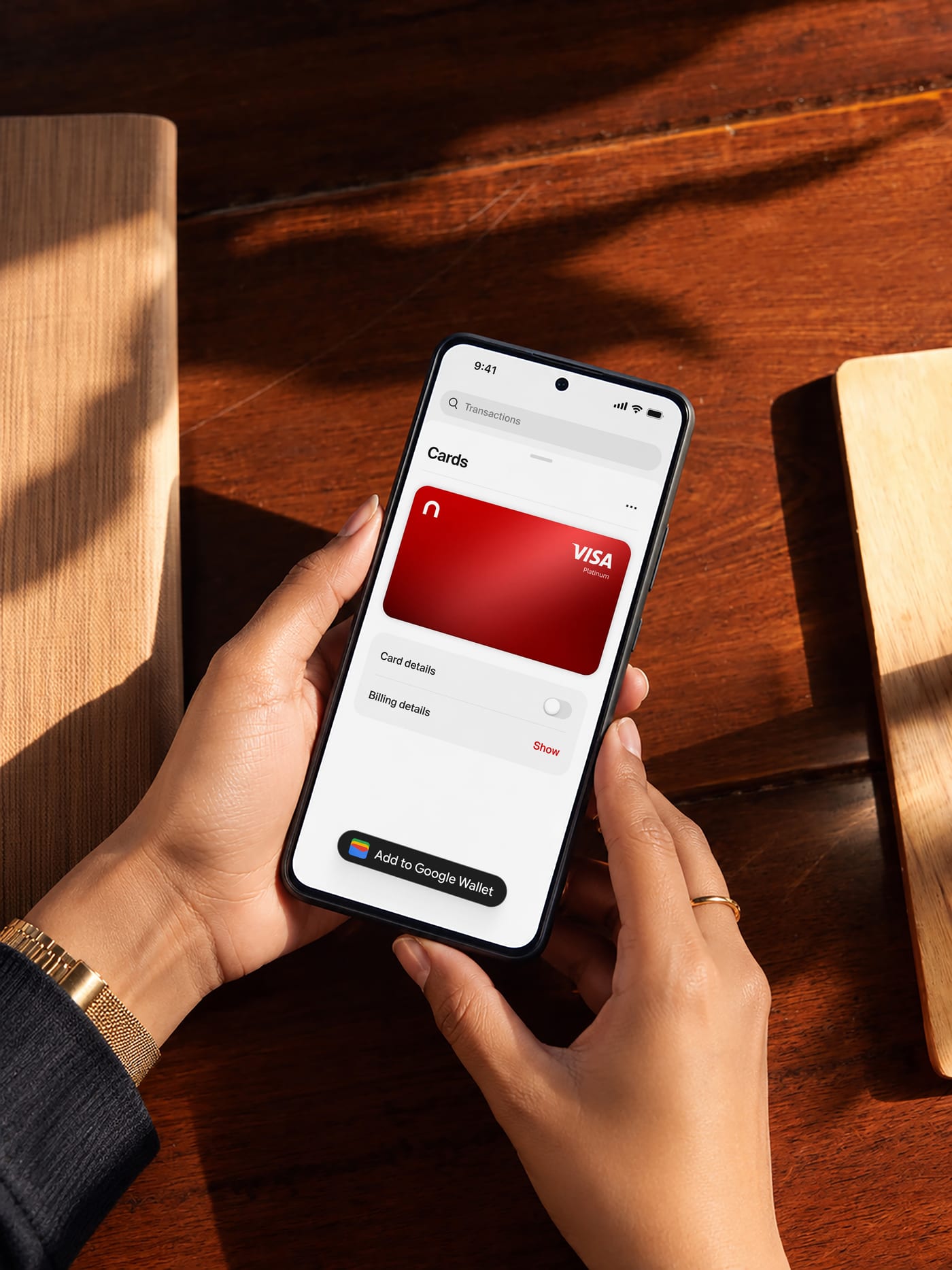 Hands holding a phone showing the red nsave card in the app